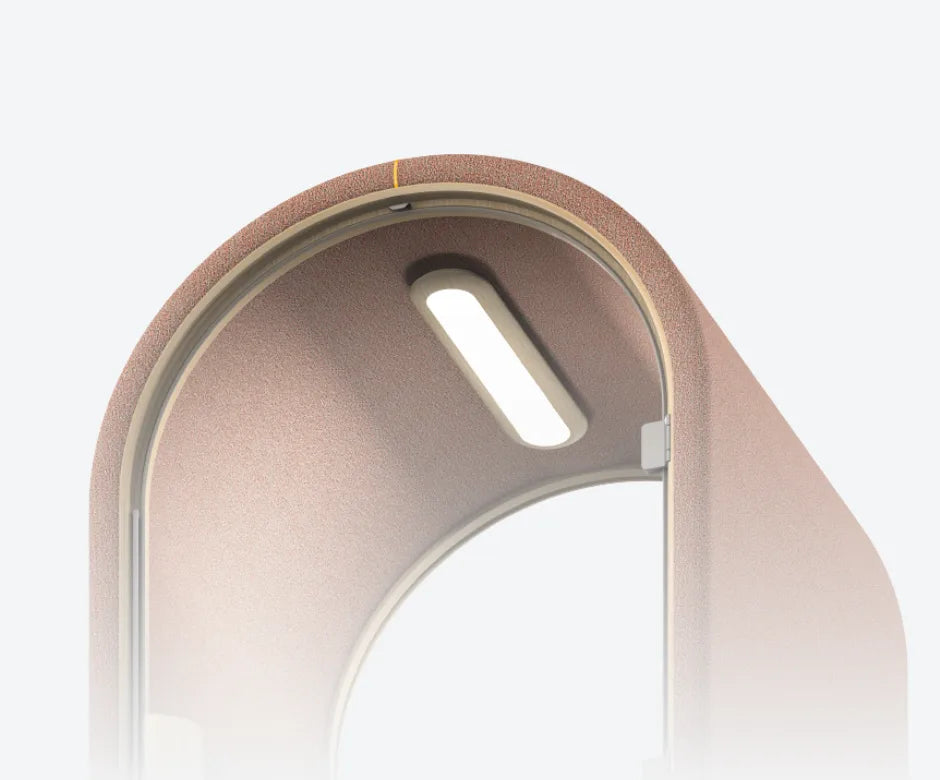Blush pink acoustic pod with curved design, glass door, built-in desk and soft seating β ideal for quiet workspaces or private calls.