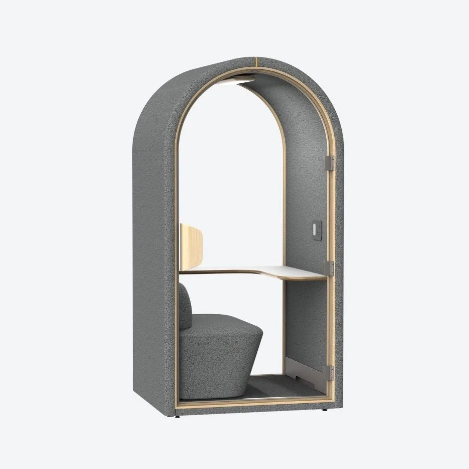 Dark grey acoustic pod with soft fabric finish, curved structure, and built-in desk β a stylish soundproof solution for modern offices.