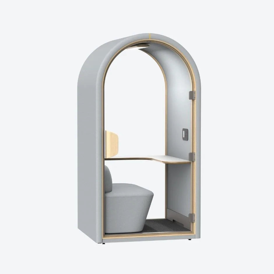 Light grey acoustic pod with curved arch design, integrated desk and soft seating β a minimalist soundproof booth for modern workspaces.